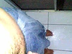 Young guy jerks off hard after a steamy shower