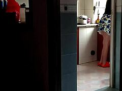 Asian milf sizzles in steamy kitchen.