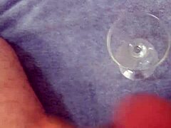 Solo cumshot captured in a glass after intense stroking