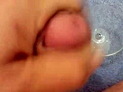 Solo cumshot captured in a glass after intense stroking