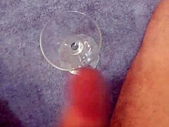 Solo cumshot captured in a glass after intense stroking
