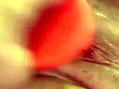Shaved pussy penetrated by thick dildo toy