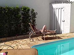 Redhead beauty in poolside action!