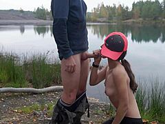Petite brunette sucks dick outdoors by the lake for cumshot