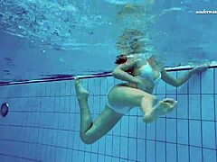 alla's bare skin in pool glows
