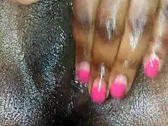 My black ebony girl rubs herself close-up