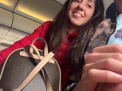 This cute teen brunette jerks off a guy on a packed plane. Risky public flashing unfolds in close-up POV.