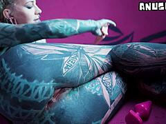 Hey, can you believe how this tattooed goth slut stretches her asshole with solo anal play and fisting? Think she can take more?