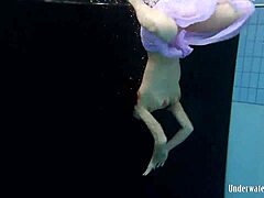 Aneta flaunts big tits in purple dress underwater in pool