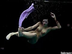 Aneta flaunts big tits in purple dress underwater in pool