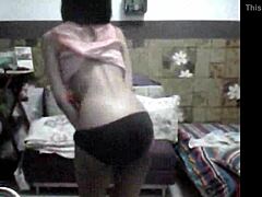 Strip tease by a teasing Asian beauty revealed