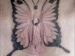 Crystal Butterfly flaunts intricate tattoo while rocking out to intense music vibes