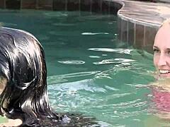 Young lesbian teens casually explore each other's wet pussies while splashing around the sunny swimming pool in a playful outdoor session.