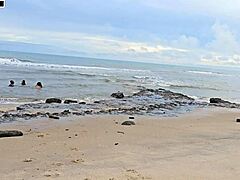 Playful game leads to intense group banging on busy beach with creampie finishes