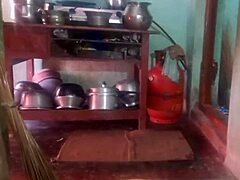 Indian sexy aunty carefully cleans plates in her outdoor home setting with friends