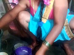 Indian sexy aunty carefully cleans plates in her outdoor home setting with friends