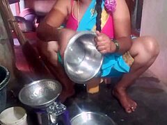 Indian sexy aunty carefully cleans plates in her outdoor home setting with friends