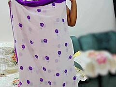 Indian bhabhi elegantly adjusts her traditional saree in a quiet moment