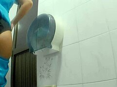 Athletic Latina chica takes a quick pee break in the public bathroom stall