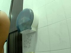 Athletic Latina chica takes a quick pee break in the public bathroom stall