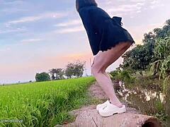 Young couple fucks doggystyle in rice field