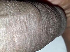Man plays with huge black cock in big close-up view