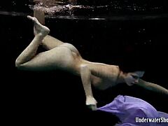 Blackhaired Aneta dives gracefully into the refreshing pool waters