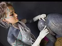 Tattooed dominatrix with unique hairstyle in alternative scene