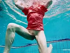 Cute russian babe swims underwater in red open dress