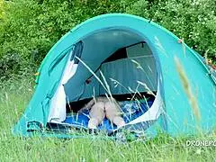 Nudist milf relaxing by the beach tent