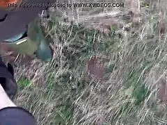 Masked redhead in boots exposes ass in public outdoor setting.