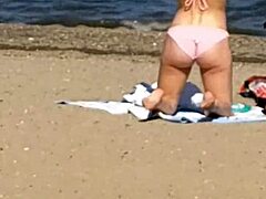 Pink princess struts on the beach with hidden candid vibes, contrasting her ass against the waves in intriguing princess style.