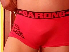 She's casually modeling her wife's panties, slipping in a dildo while lounging in lingerie and nylons.