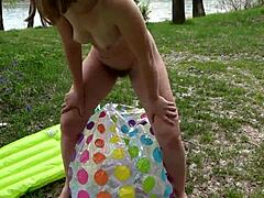 Man, this milf's hairy pussy got pissed on, spat at, and fucked hard with a beach ball outdoors on the public river bank