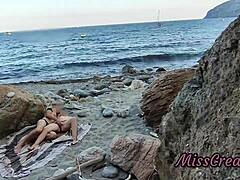 She flashes her pussy at a guy on the public beach. He helps her squirt in this risky hidden cam moment.