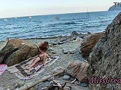 She flashes her pussy at a guy on the public beach. He helps her squirt in this risky hidden cam moment.