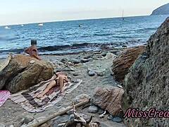 She flashes her pussy at a guy on the public beach. He helps her squirt in this risky hidden cam moment.