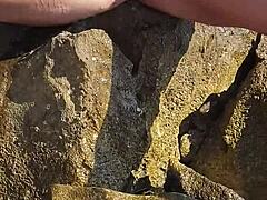 nina black horny shaved pussy public outdoor peeing by crashing sea waves