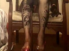 Crossdresser Maria struts in sheer black nylon pantyhose high heels miniskirt