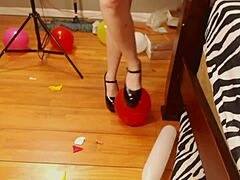 Fifi Foxx pops balloons while wearing high heels