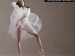 Blonde gymnast stretches flexibly during naked yoga workout in gym