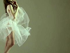 Blonde gymnast stretches flexibly during naked yoga workout in gym