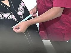 Doctor Examines Hijab-Wearing Arab Patient in Hospital Setting Closely