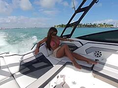 tanned brunette with huge fake tits small waist flashes bikini thong ass on boat