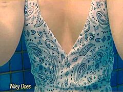 check out this hot milf wife flashing big tits at the hotel pool in her one-piece swimsuit.