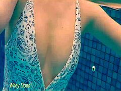 check out this hot milf wife flashing big tits at the hotel pool in her one-piece swimsuit.