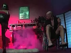 Costumed blondes eagerly suck and ride his cock.