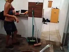 Blonde MILF shows off big tits while cooking in the kitchen