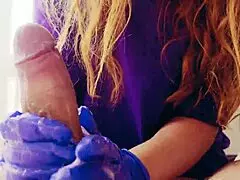 Watch this sexy redhead give a close-up handjob in gloves, covering everything in cum!