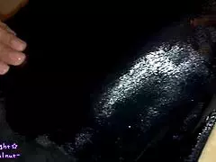 Transsexual in navy blue swimsuit gets coated with slippery lotion